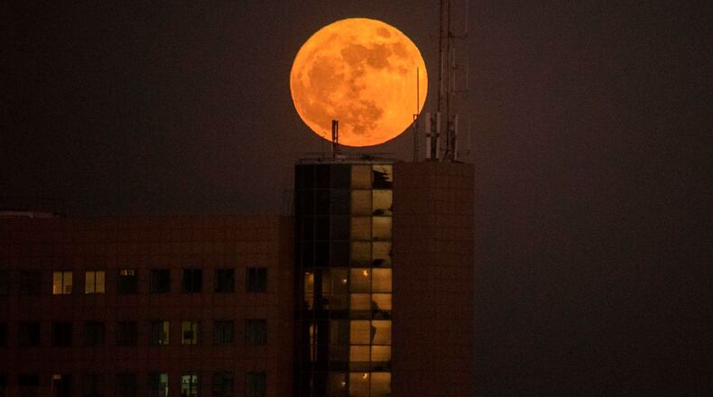 The supermoon rises over a building in the Israeli city of Netanya on Sunday.