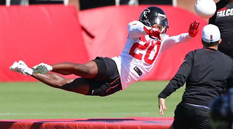 Falcons cornerback Kendall Sheffield stretches out to block a soccer ball while running an agility drill during the third practice of training camp Wednesday, July 24, 2019, in Flowery Branch.