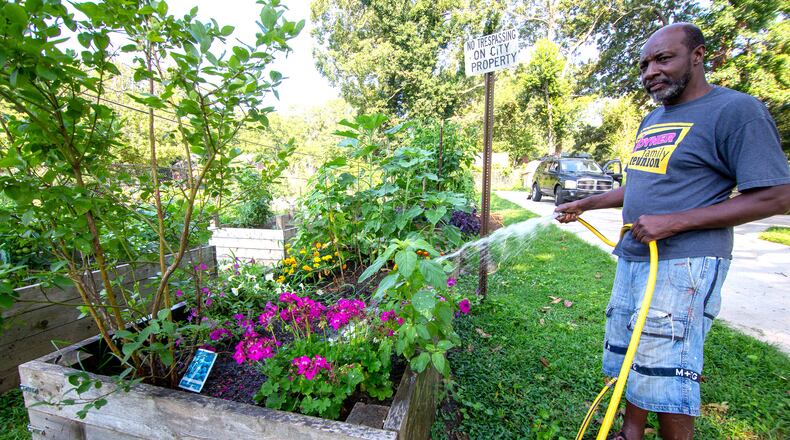 Sammy Sheperd waters his plants at the Capital View Community Garden near Perkerson Park Monday, July 05, 2021. Fulton Commissioners recently adopted a plan to promote and educate residents about local food options, especially small farming and community garden programs. STEVE SCHAEFER FOR THE ATLANTA JOURNAL-CONSTITUTION