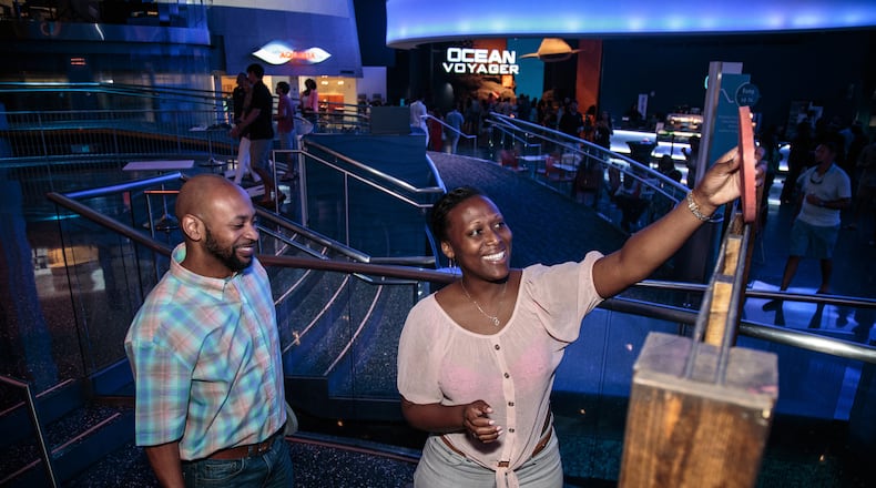 Corry Dupriest (L) and JaNive Johnson play a game of Connect Four during the Sips Under the Sea, Game Night, at Georgia Aquarium in Atlanta last year. STEVE SCHAEFER / SPECIAL TO THE AJC