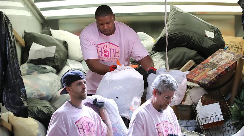 Josh Steedley, (from left) Alvin Bailey and Daniel Odom, all formerly homeless, unload donated items from a truck at the Nspire Outreach and HOPE for Domestic Violence warehouse on Monday, March 30, 2020, in Duluth. With so many counties and cities ordering folks to stay home, many have found it’s a good time to clear out clutter. But then what do you do with it? Several charitable organizations, viewed as essential services because they are providing food, clothing and shelter to the homeless and others in need, are still doing pickups. CURTIS COMPTON CCOMPTON@AJC.COM