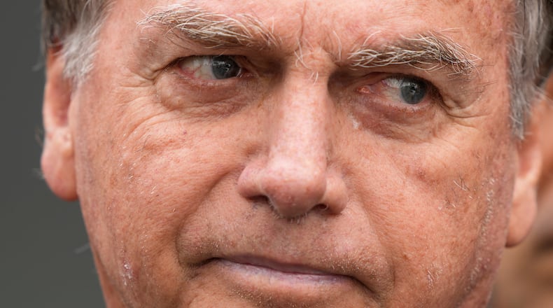 FILE - Brazil's former President Jair Bolsonaro, temporarily allowed out of house arrest for medical treatment, departs a hospital in Brasilia, Brazil, Sept. 14, 2025. (AP Photo/Eraldo Peres, File)