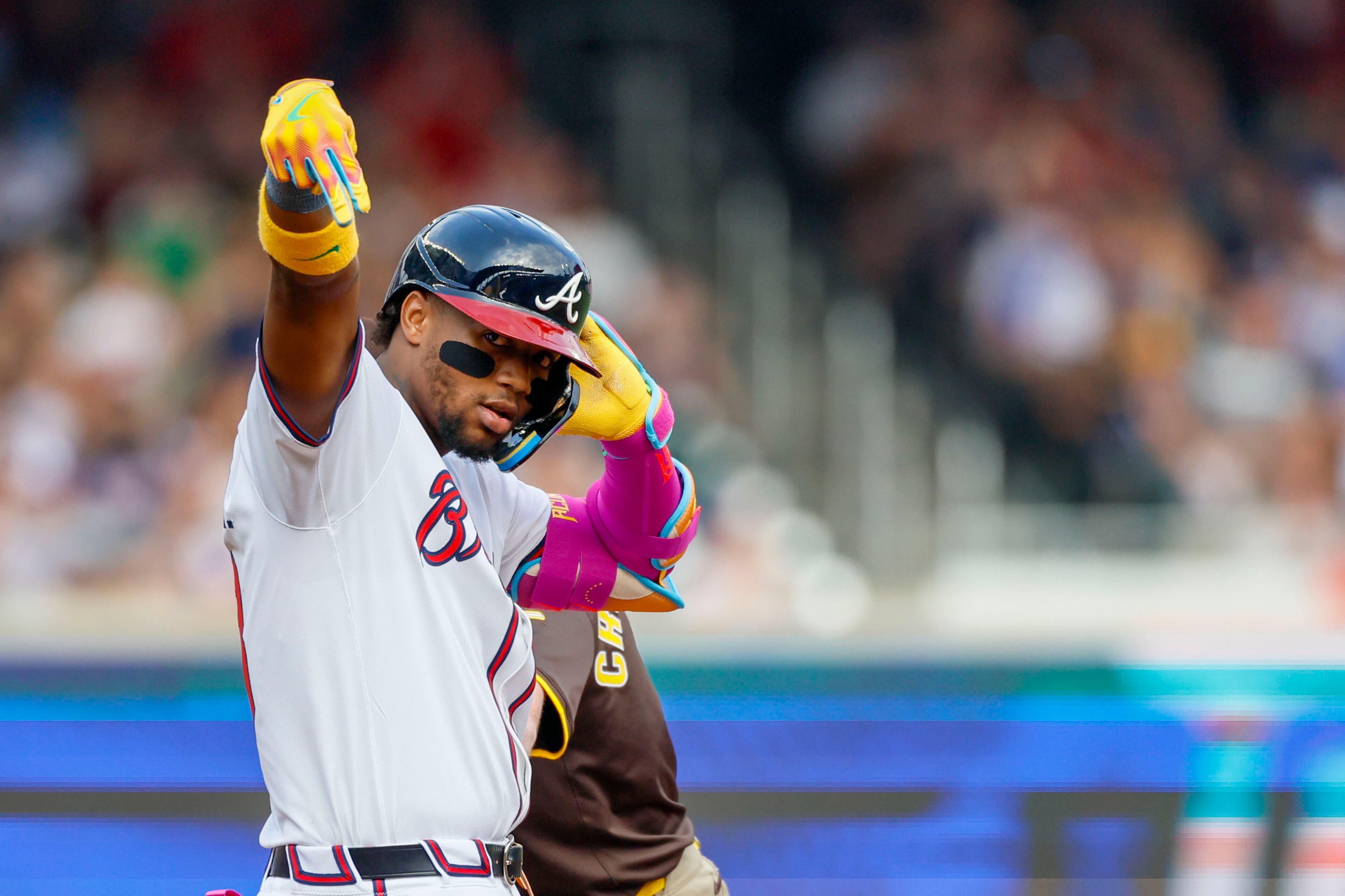 Atlanta Braves' Ronald Acuña Jr. (13) reacts with teammates after hitting a double during the fifth inning of a baseball game against the San Diego Padres on Sunday, May 25, 2025, in Atlanta. (Miguel Martinez/Atlanta Journal-Constitution via AP)