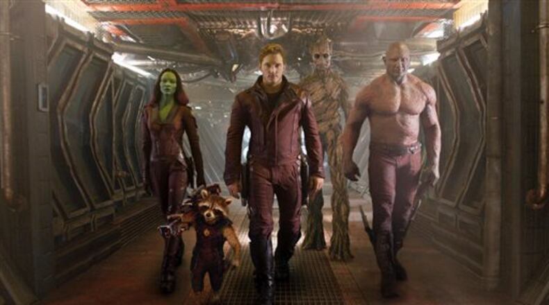 This image released by Disney - Marvel shows, from left, Zoe Saldana, the character Rocket Racoon, voiced by Bladley Cooper, Chris Pratt, the character Groot, voiced by Vin Diesel and Dave Bautista in a scene from "Guardians Of The Galaxy." (AP Photo/Disney - Marvel)