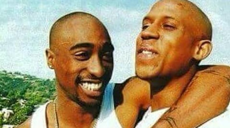 “Rest in Paradise,” The Outlawz wrote in a Sunday Twitter post that featured a photo of Hussein Fatal (left) with Tupac Shakur. (Credit: Twitter)