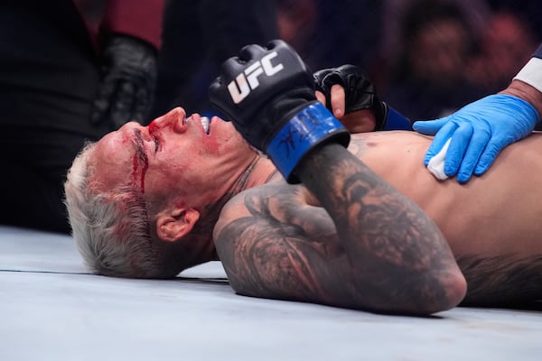 Charles Oliveira lies on the mat after losing to Ilia Topuria in a lightweight title fight at UFC 317, Saturday, June 28, 2025, in Las Vegas. (AP Photo/John Locher)