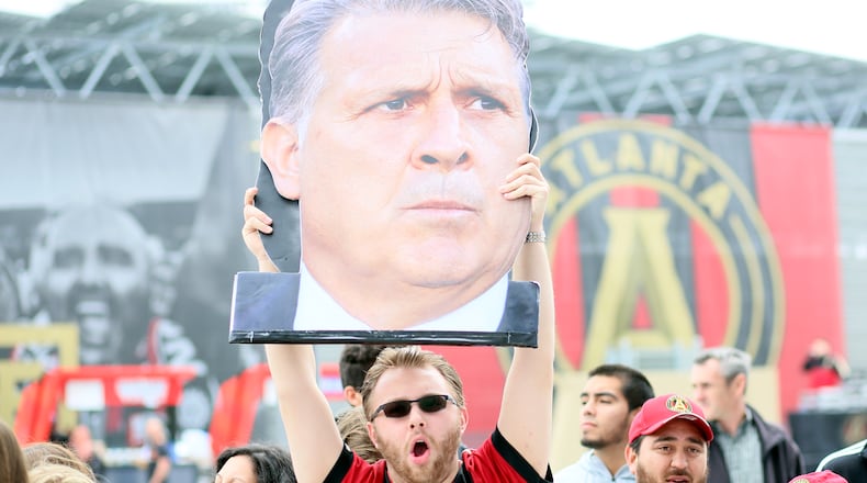 April 7, 2018. Founding member Nick Tewell from Atlanta holds a Atlanta United coach banner Gerdado 'Tata' Martino as the team arrives to the Mercedes-Benz stadium on April 7, 2018 in Atlanta Ga..