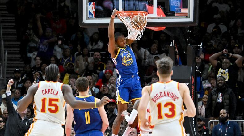Golden State Warriors forward Jonathan Kuminga dunks against the Atlanta Hawks during the fourth quarter in an NBA basketball game at State Farm Arena, Saturday, February 3, 2024, in Atlanta. The Hawks acquired Kuminga and Buddy Hield in a trade in exchange for Kristaps Porzingis. (Hyosub Shin/AJC)
