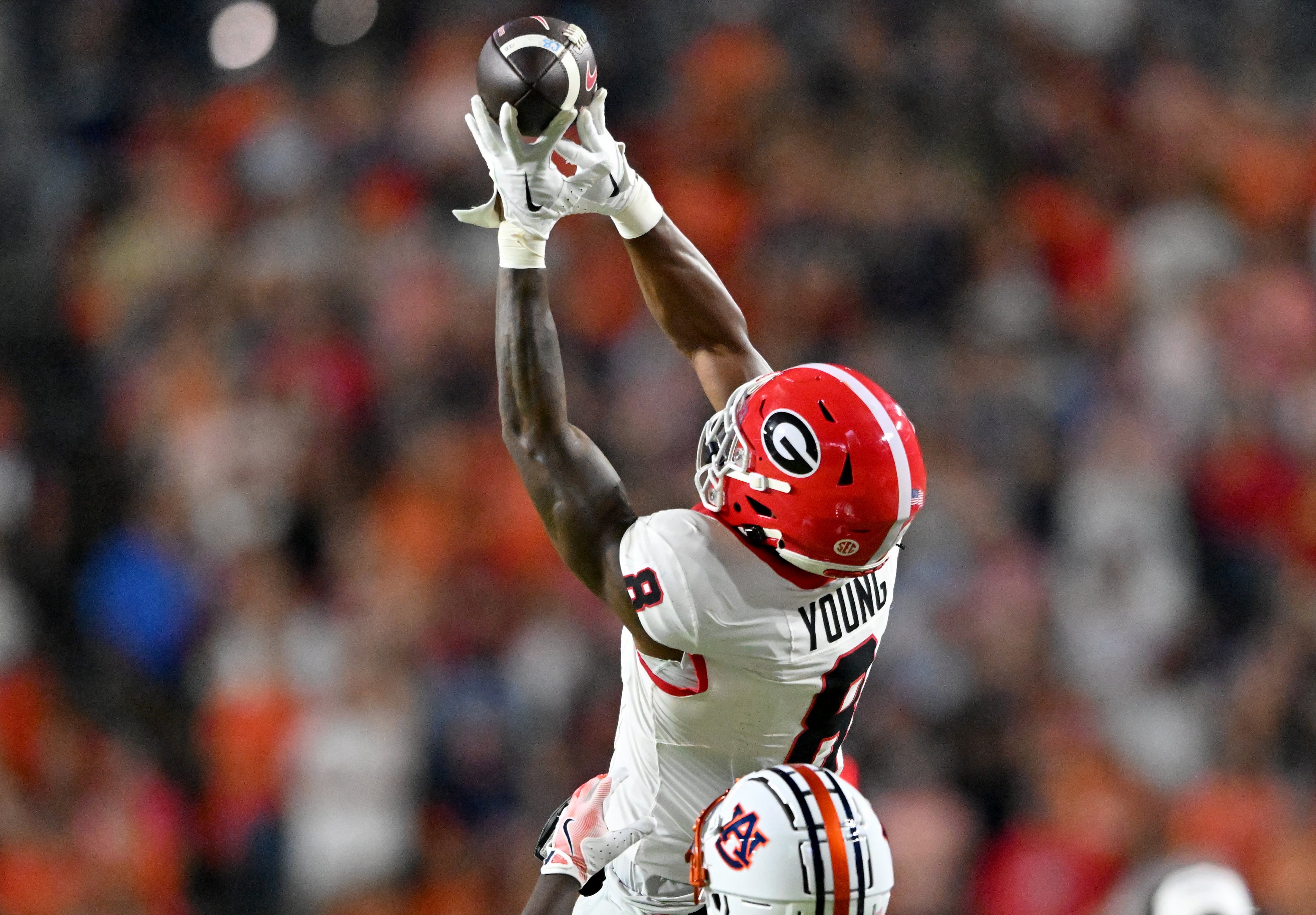Georgia wide receiver Colbie Young (8) is not able to catch under pressure from Auburn defensive back Rayshawn Pleasant (14) during the second half in a NCAA college football game at Jordan-Hare Stadium, Saturday, October 11, 2025, in Auburn, Ala. Georgia won 20-10 overAuburn. (Hyosub Shin / AJC)