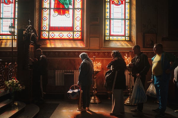 People stand in line to kiss an icon during the celebration of Orthodox Easter at Cross Lower Church of the Ukrainian Orthodox Church in Kharkiv, Ukraine, on Sunday, April 20, 2025. (AP Photo/George Ivanchenko)
