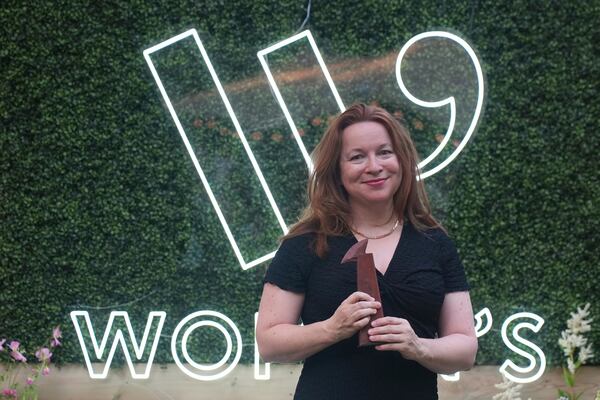 Winner of the Women's Prize for Fiction Rachel Clarke for her book 'The Story of a Heart' holds her trophy as she poses for the media in London, Thursday, June 12, 2025. (AP Photo/Joanna Chan)