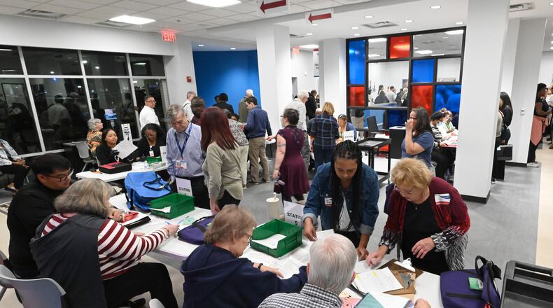 Poll workers bring in bags containing ballots from various precincts on Election Day at Gwinnett County Voter Registrations & Elections, Tuesday, November 5, 2024, in Lawrenceville. (Hyosub Shin / AJC)