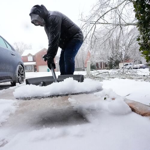 David Bentley shovels ice and snow from his driveway during a winter storm Sunday, Jan. 25, 2026, in Nashville, Tenn. (AP Photo/George Walker IV)
