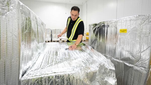 A UPS Healthcare employee conducts temperature checks on a shipment inside a temperature-controlled cross-dock facility. (Courtesy of UPS Healthcare)