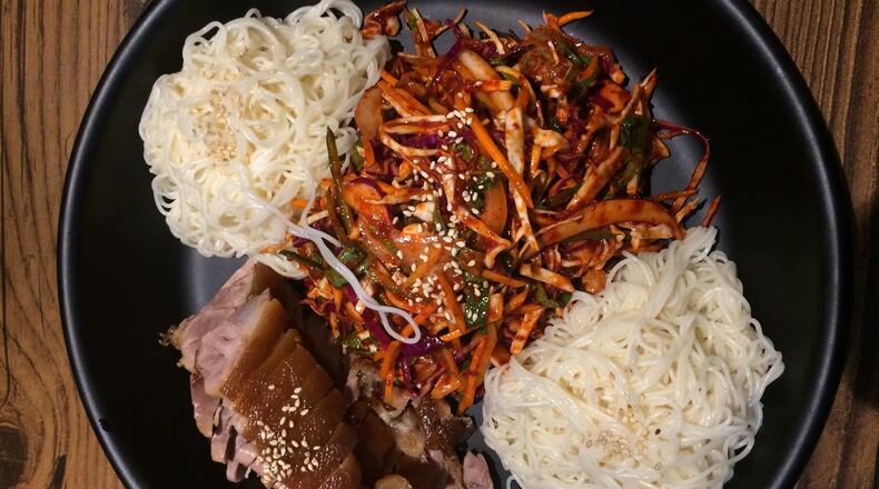 Jok Ga A Dong Chim, a Duluth restaurant specializing in pig’s feet, offers a combination platter pairing the pork (lower left) with a spicy sea-snail salad. Our critic says it’s the best thing on the menu. CONTRIBUTED BY WENDELL BROCK