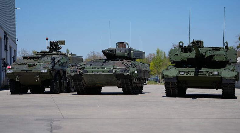FILE - A boxer armoured personnel carrier, from left, a Puma infantry fighting vehicle and a Leopard battle tank are displayed during the opening of a new production line production line of Boxer 8x8 wheeled armoured personnel carrier produced by pan-European defense company KNDS in Munich, Germany, on April 22, 2026. (AP Photo/Matthias Schrader, File)
