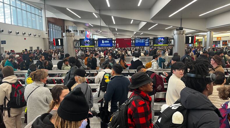 Lines of travelers were winding through the baggage claim area of the domestic terminal at Hartsfield-Jackson International Airport on Saturday, January 11, 2025. (Arvin Temkar / AJC)