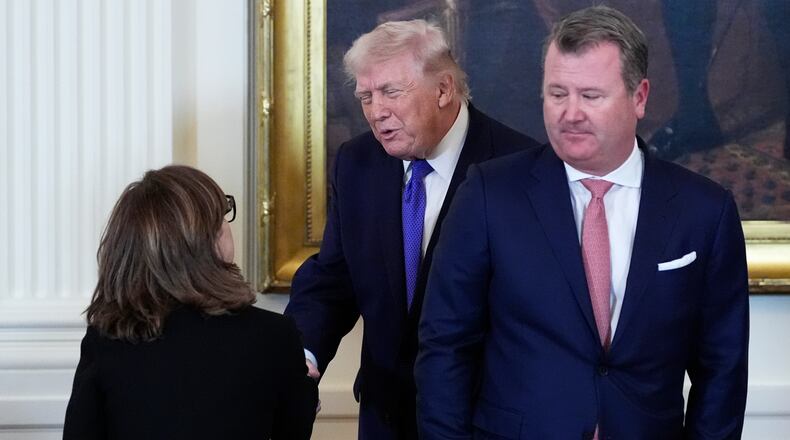 President Donald Trump speaks with Chairman, President and Chief Executive Officer of Marathon Petroleum Maryann Mannen, left, while Tallgrass Energy President and Chief Executive Officer Matt Sheehy looks on, right, during a meeting with oil executives in the East Room of the White House, Friday, Jan. 9, 2026, in Washington. (AP Photo/Alex Brandon)