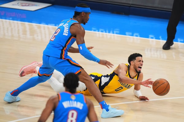 Indiana Pacers guard Tyrese Haliburton (0) falls to the court with an injury during the first half of Game 7 of the NBA Finals basketball series against the Oklahoma City Thunder Sunday, June 22, 2025, in Oklahoma City. (AP Photo/Nate Billings)