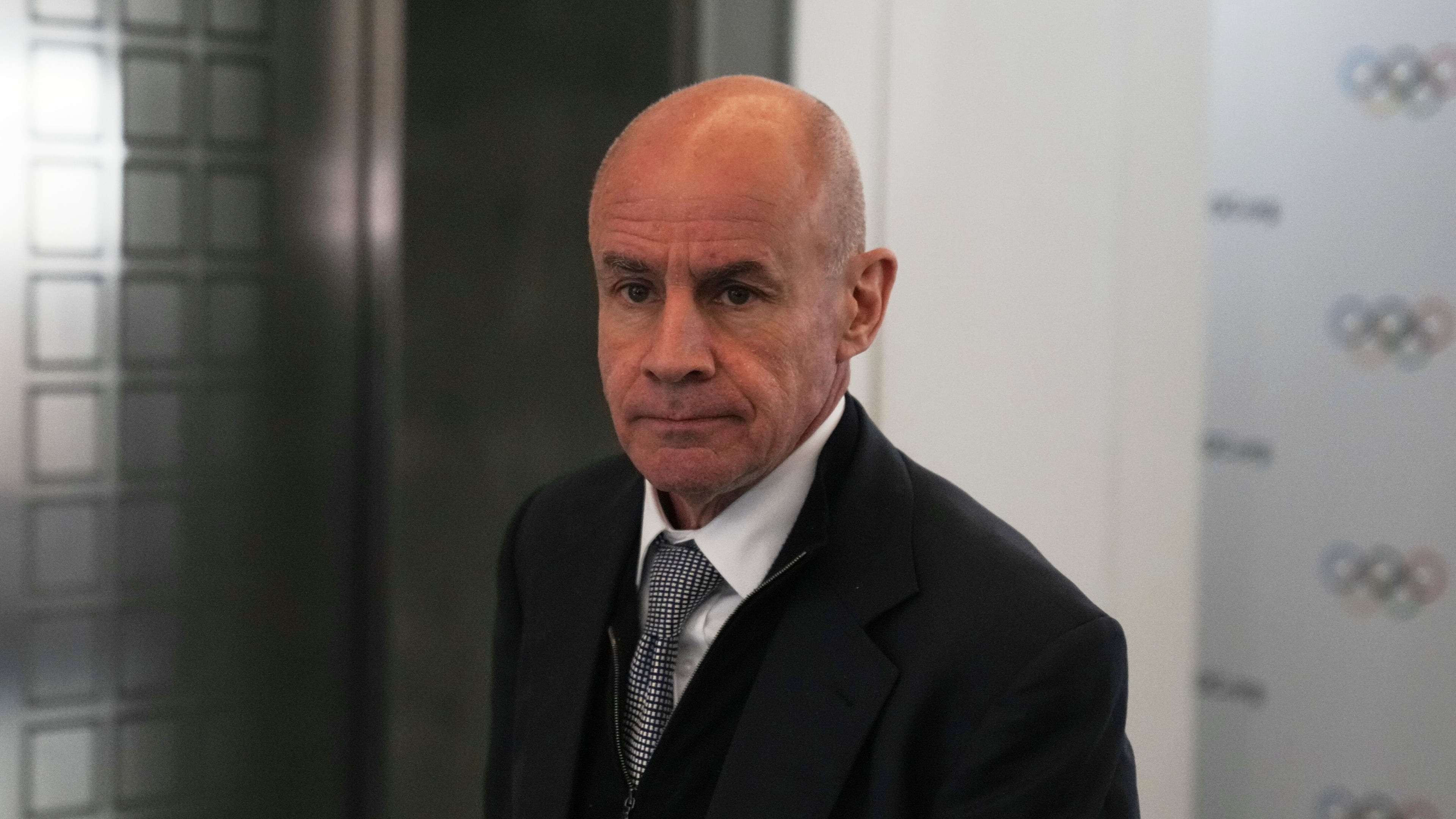 FILE - Candidate to the presidency of the International Olympic Committee Johan Eliasch arrives at the mixed zone during a break of the 144th session, which will elect the new IOC President, in Costa Navarino, western Greece, March 19, 2025. (AP Photo/Thanassis Stavrakis, File)