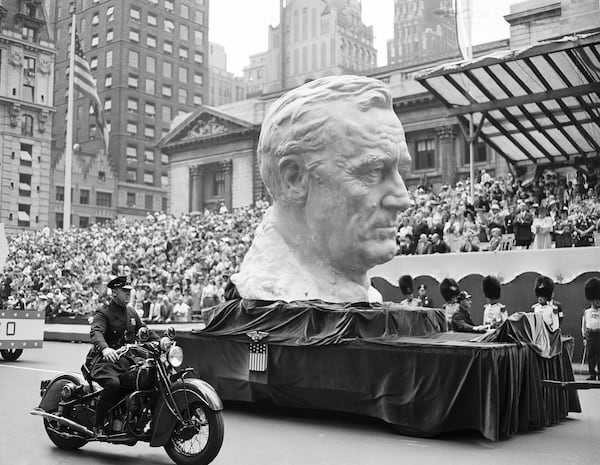 FILE - A float carrying a huge bust of President Franklin Roosevelt rolls up Fifth Avenue during a war parade in New York, June 13, 1942. (AP Photo, File)