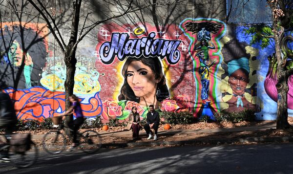 Ali Abdulrab and Asya Morgan talk in front of the mural of the murder victim Abdulrab's sister, Mariam, on Wylie Street near the Krog Street tunnel. Ali Abdulrab and Asya Morgan have become activists seeking to strengthen the way the state oversees sex offenders. (Hyosub Shin / Hyosub.Shin@ajc.com)