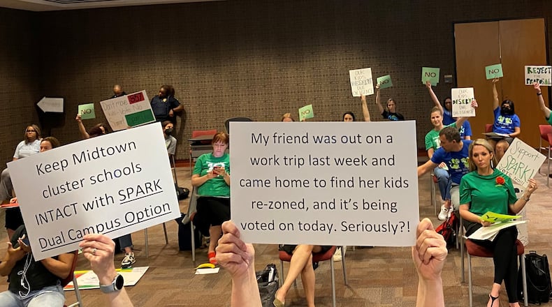 Critics of an Atlanta Public Schools' plan to rezone Midtown-area elementary campuses protest during a Monday, May 2, 2022, board meeting. VANESSA McCRAY/AJC