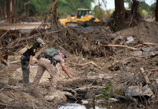 Upton County sheriff deputies do search and recovery work on the banks of the Guadalupe River in Ingram, Texas, Tuesday, July 8, 2025, after the Fourth of July flood. (Jay Janner/Austin American-Statesman via AP)