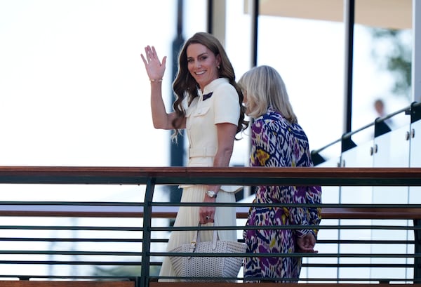 Britain's Kate, Princess of Wales waves as she arrives with Deborah Jevans of the All England Club to attend the women's singles final between Poland's Iga Swiatek and Amanda Anisimova of the US at the Wimbledon Tennis Championships in London, Saturday, July 12, 2025. (Andrew Matthews/PA via AP)