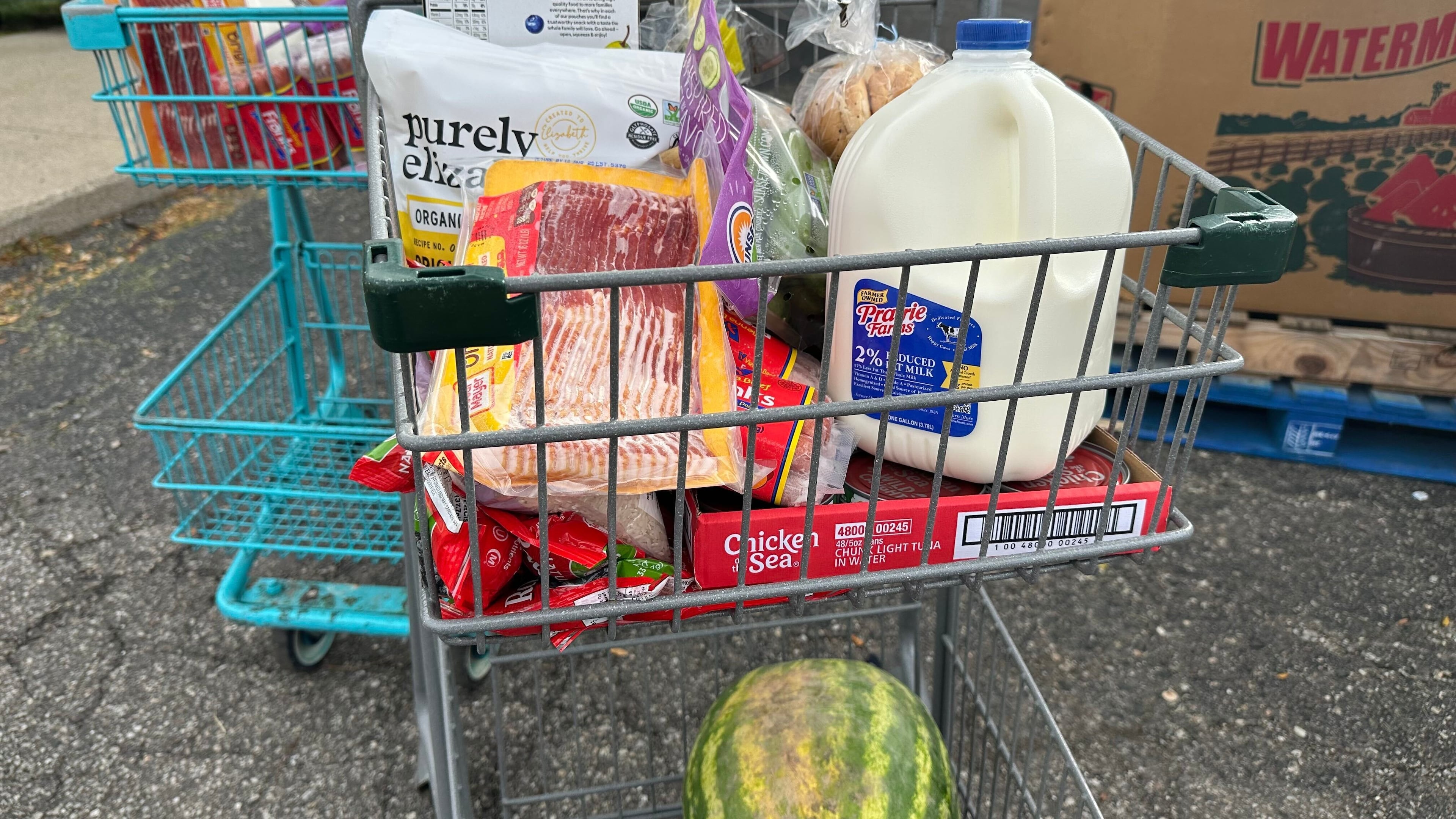 Food and milk sit in a shopping cart during a Forgotten Harvest distribution event held at Woodside Bible Church, Friday, Oct. 24, 2025, in Pontiac, Mich. (AP Photo/Mike Householder)