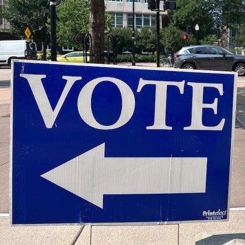 A person walks past a sign for a polling place on the first day of in-person absentee voting for Wisconsin's chaotic Democratic primary for governor Tuesday, July 28, 2026, in Madison, Wis. (AP Photo/Scott Bauer)
