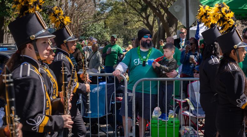 Knox Hersey, 5, plays his toy horn, along with a marching band during the 201st Savannah St. Patrick’s Day Parade on March 17, 2025 in Savannah, GA. (Justin Taylor for the Atlanta Journal-Constitution)