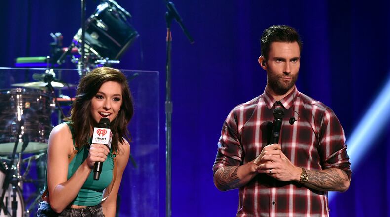 BURBANK, CA - AUGUST 26: Singers Christina Grimmie (L) and Adam Levine speak onstage druing the iHeartRadio Album Release Party with Maroon 5 LIVE on the CW at iHeartRadio Theater on August 26, 2014 in Burbank, California. According to Grimmie's brother, Marcus Grimmie, Levine has offered to pay for his sister's funeral. She was killed while signing autographs after an Orlando, Florida, show. (Photo by Kevin Winter/Getty Images for Clear Channel)