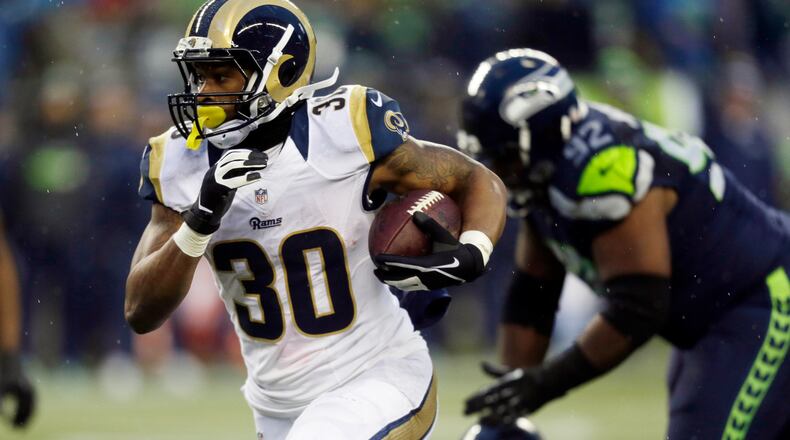 FILE - In this Sunday Dec. 27, 2015, file photo, St. Louis Rams' Todd Gurley runs against the Seattle Seahawks in the second half of an NFL football game in Seattle. Rams phenom Todd Gurley seems to have an inside track for the top pick in 2016, but he will have some stiff competition from wide receivers. (AP Photo/Stephen Brashear, File)