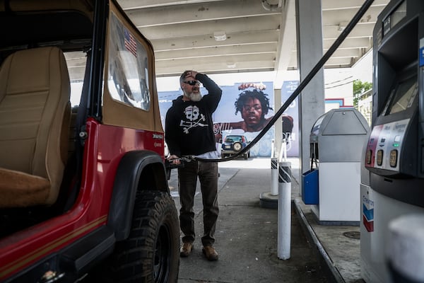 Duncan Butler fills up his gas tank at Buddy’s gas station in Atlanta in April. (Abbey Cutrer/AJC)