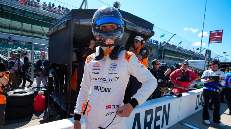 FILE - Christian Lundgaard, of Denmark, waits to climb into his car before the start practice for the Indianapolis 500 auto race at Indianapolis Motor Speedway in Indianapolis, May 23, 2025. (AP Photo/Michael Conroy, File)