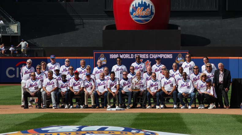 Members of the 1986 New York Mets team that won a World Series and family members pose for a group photo during a reunion celebration for the team, Saturday, Aug. 1, 2026, in New York. (AP Photo/Heather Khalifa)