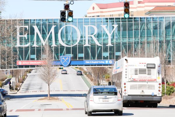 A Marta bus travels along Clifton Road, a thoroughfare that cuts through Emory University's campus in Atlanta, in this file photo. (Miguel Martinez/AJC)