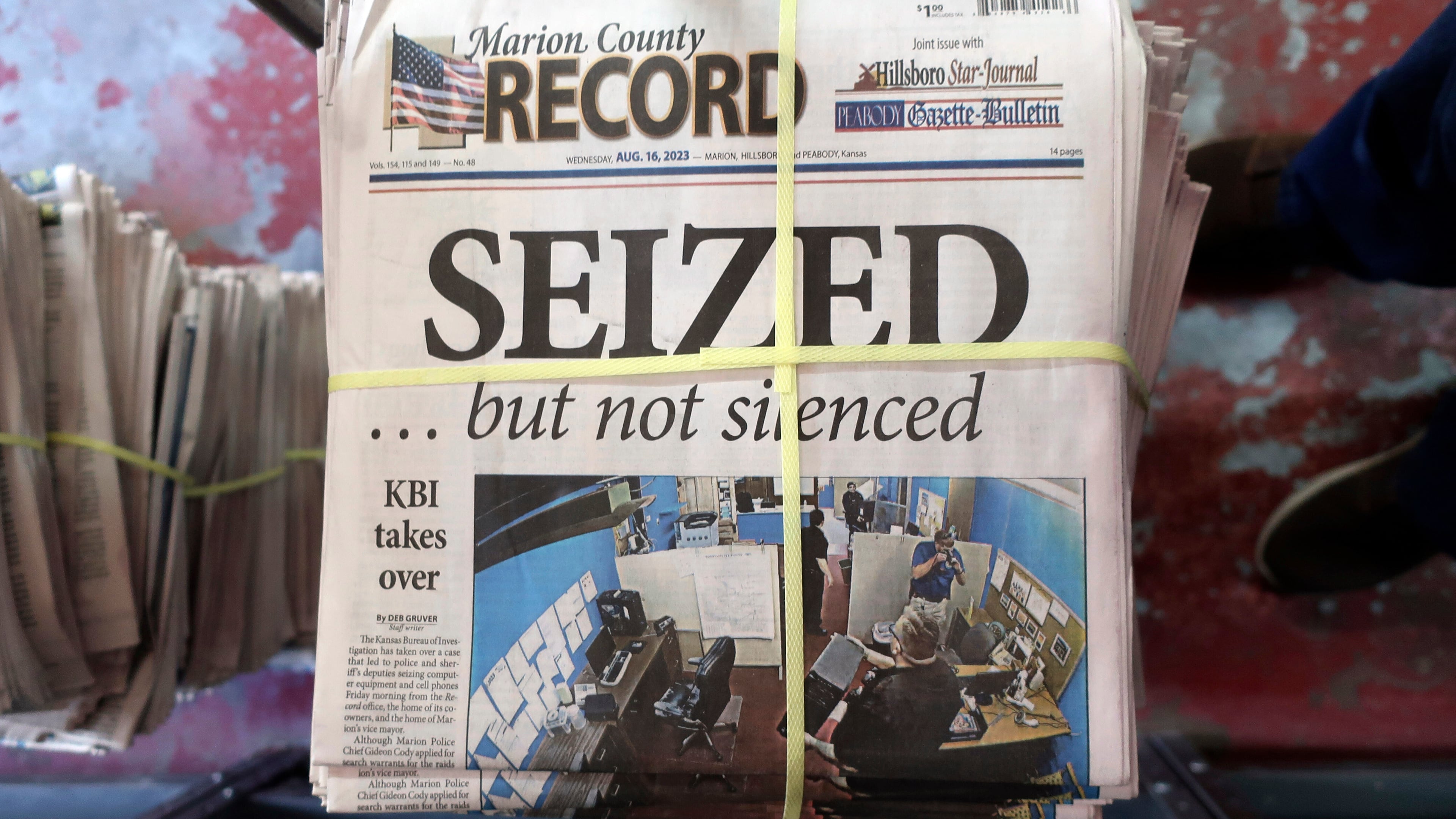 FILE - A stack of the Marion County Record sits in the back of the newspaper's building, awaiting unbundling, sorting and distribution, Aug. 16, 2023, in Marion, Kan. A former reporter for a weekly Kansas newspaper has agreed to accept $235,000 to settle part of her federal lawsuit over a police raid on the paper that made a small town the focus of a national debate over press freedoms. (AP Photo/John Hanna, File)
