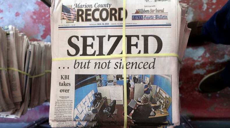 FILE - A stack of the Marion County Record sits in the back of the newspaper's building, awaiting unbundling, sorting and distribution, Aug. 16, 2023, in Marion, Kan. A former reporter for a weekly Kansas newspaper has agreed to accept $235,000 to settle part of her federal lawsuit over a police raid on the paper that made a small town the focus of a national debate over press freedoms. (AP Photo/John Hanna, File)