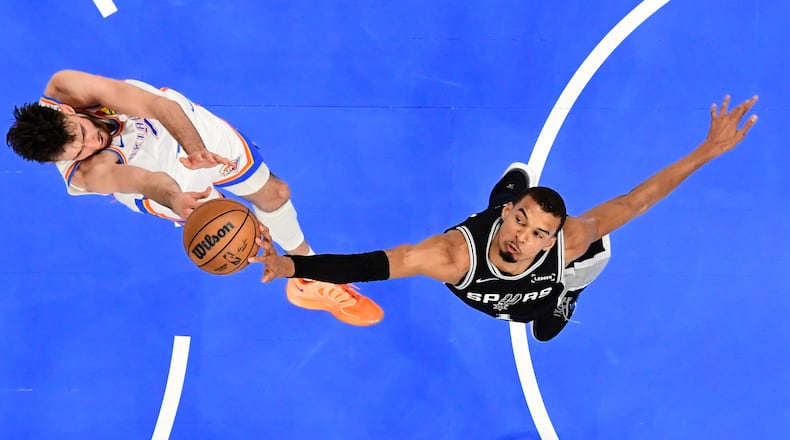 San Antonio Spurs forward Victor Wembanyama, right, blocks a shot by Oklahoma City Thunder center Chet Holmgren during the first half in Game 5 in the Western Conference finals NBA basketball playoffs series, Tuesday, May 26, 2026, in Oklahoma City. (AP Photo/Gerald Leong)