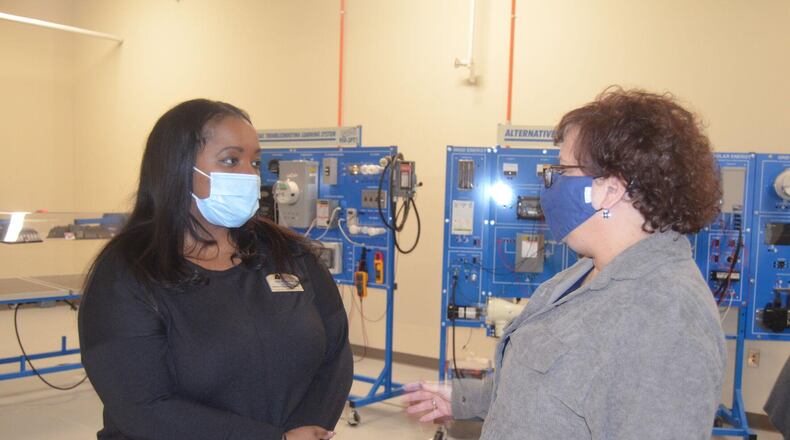 Lisa Stephens, dean of business/health care/technology at Albany Technical College, left, has a conversation with Lisa Harrell, dean of academic affairs, on Tuesday.
