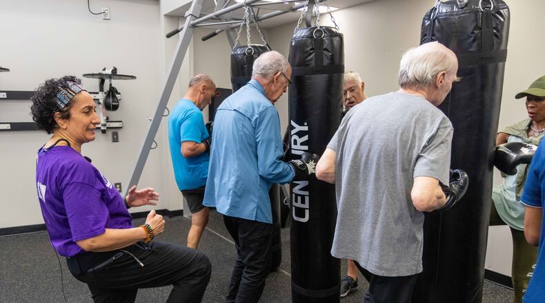 Nausheen Quraishy (left), a Rock Steady Boxing Instructor, teaches a class to help people with Parkinson's exercise and try to regain their strength at the Kennestone Health Place at Kennestone Hospital in Kennesaw. (Phil Skinner for the AJC)