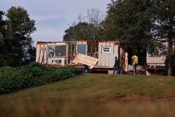 Construction workers deconstruct Doc’s Café in Roswell. (Natrice Miller/ AJC)