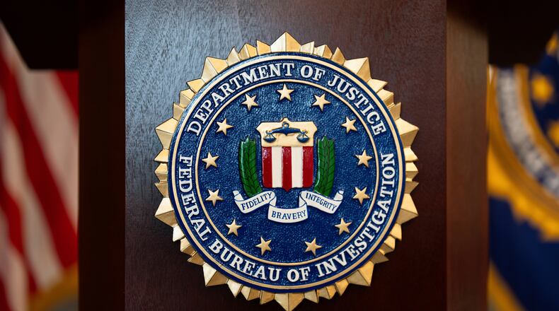 FILE - An FBI seal is displayed on a podium before a news conference at the field office in Portland, Ore., Jan. 16, 2025. (AP Photo/Jenny Kane, File)
