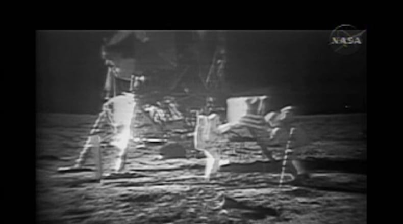 This photo from NASA TV shows the Apollo 11 astronauts on the lunar surface after landing in 1969.