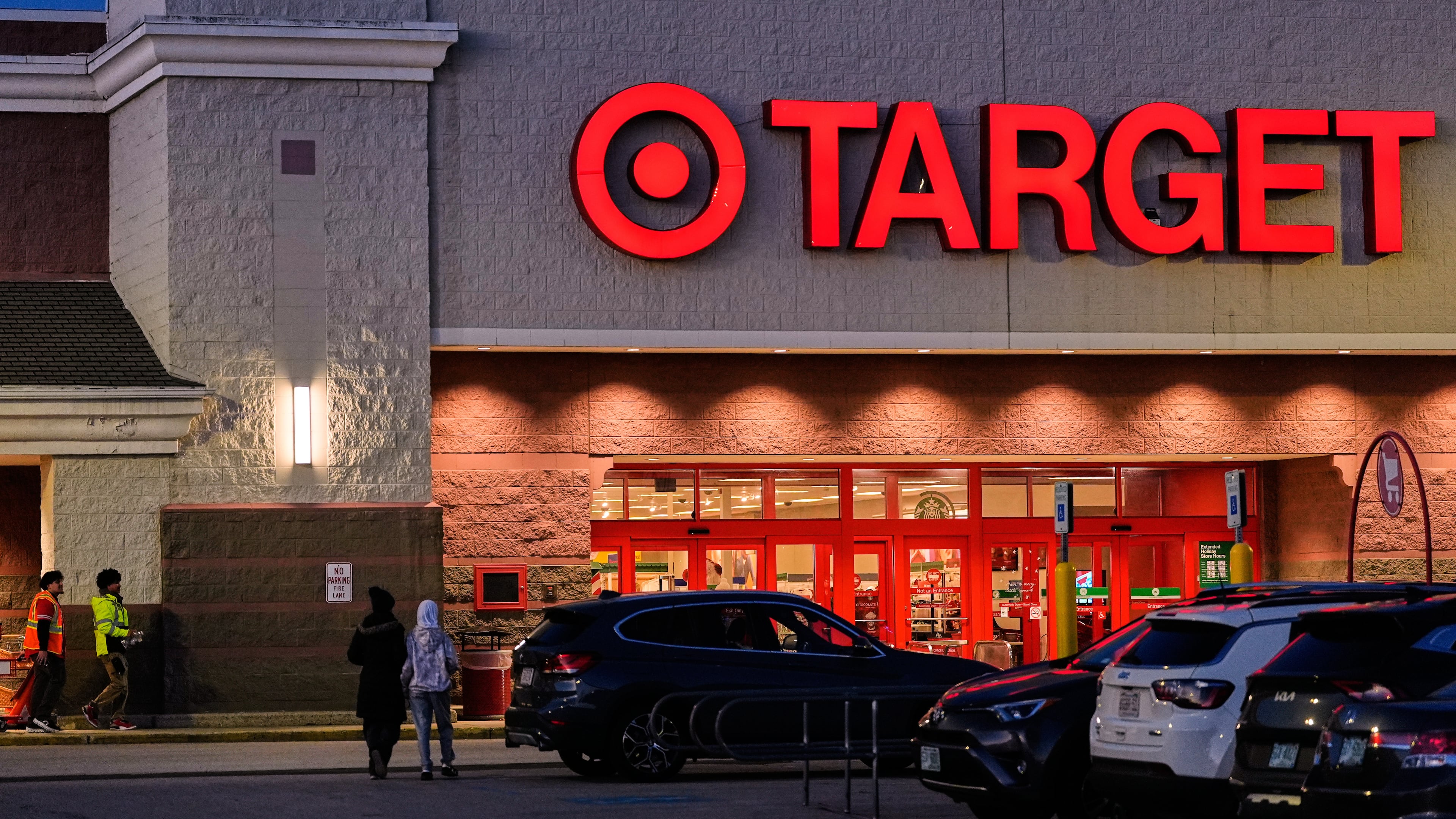 Shoppers walk towards a Target retail store, Tuesday, Nov. 18, 2025, in Salem, N.H. (AP Photo/Charles Krupa)
