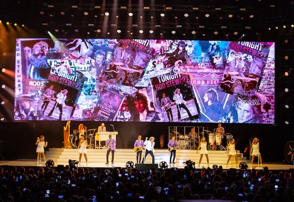 A few minutes before 9 p.m., Rod Stewart — with his spiky blonde hair and wearing a white suit jacket and black slacks — hit the stage. “It’s ridiculously hot, but we’re ready for you,” Stewart said. (Ryan Fleisher for the AJC)