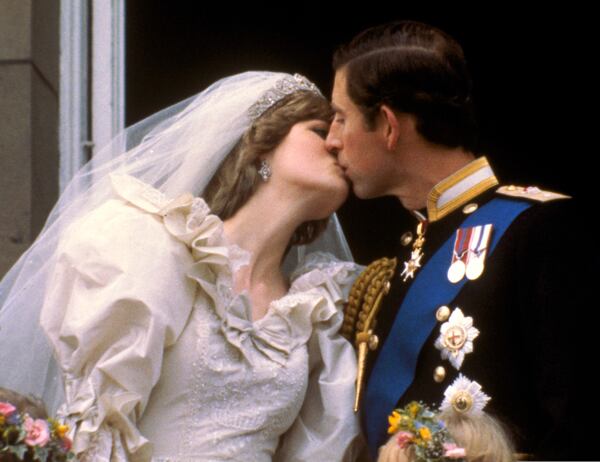 FILE - Britain's Prince Charles kisses his bride, Princess Diana, on the balcony of Buckingham Palace in London, July 29, 1981, after their wedding. (AP Photo, File)