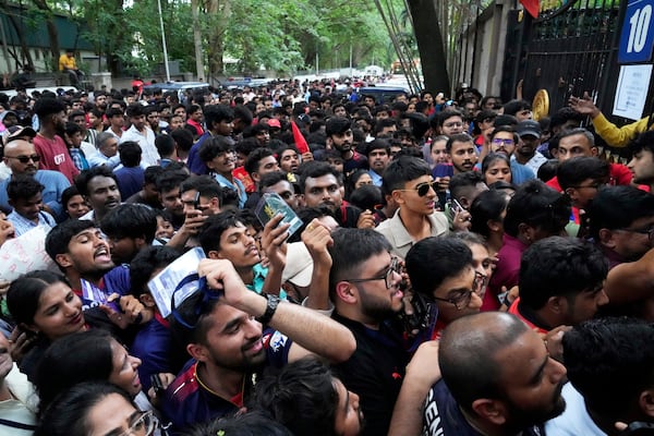 Fans wait to enter M. Chinnaswamy Stadium to celebrate Royal Challengers Bengaluru's victory in the Indian Premier League cricket tournament, in Bengaluru, India, Wednesday, June 4, 2025. (AP Photo/Aijaz Rahi)